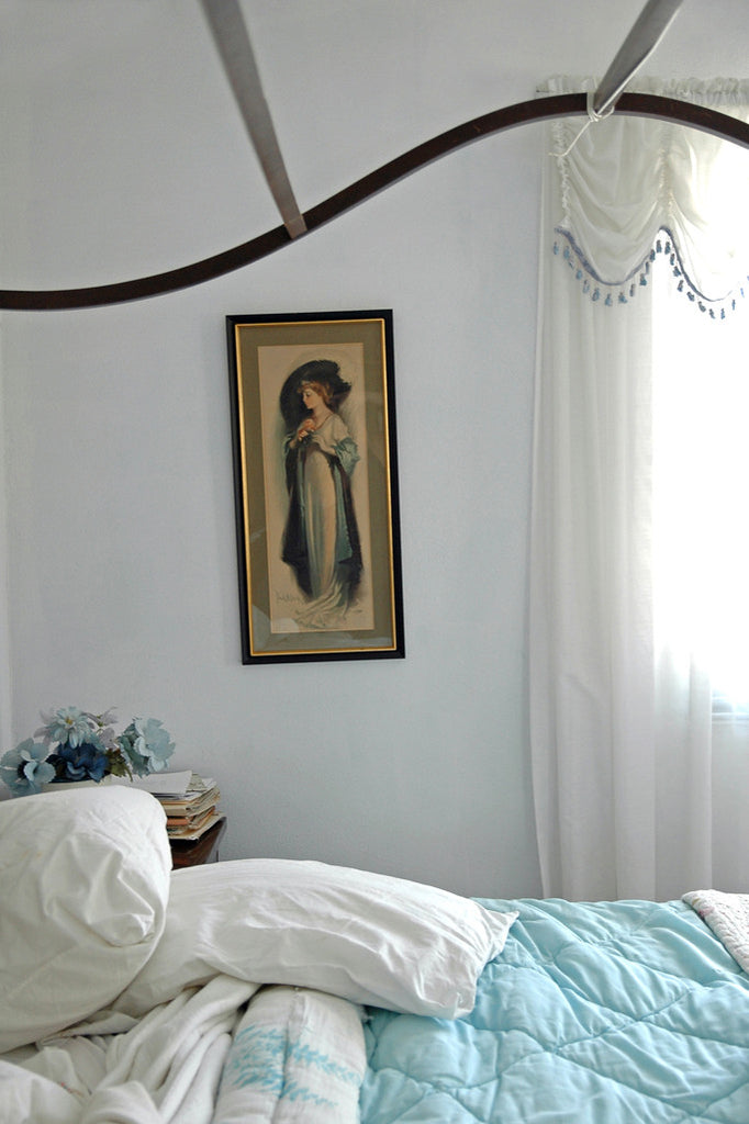 "Blue Flowers" ~ A section of a bedroom with a canopy bed, a vintage art print on the wall and a bowl of blue flowers in the corner. El Paso, TX