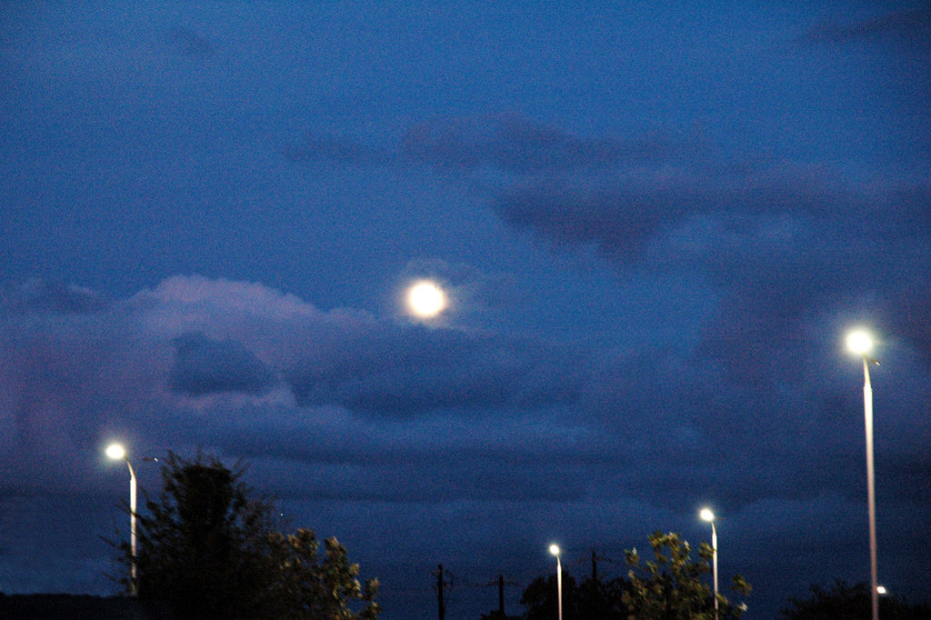 "Moons" ~ A full moon and moon-like street lights all together. Photo by Ann Woodall